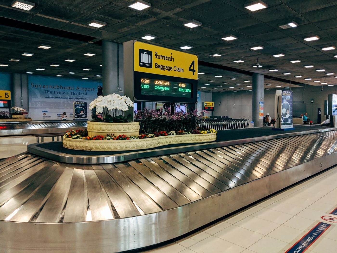Baggage claim carousel inside an airport arrivals hall