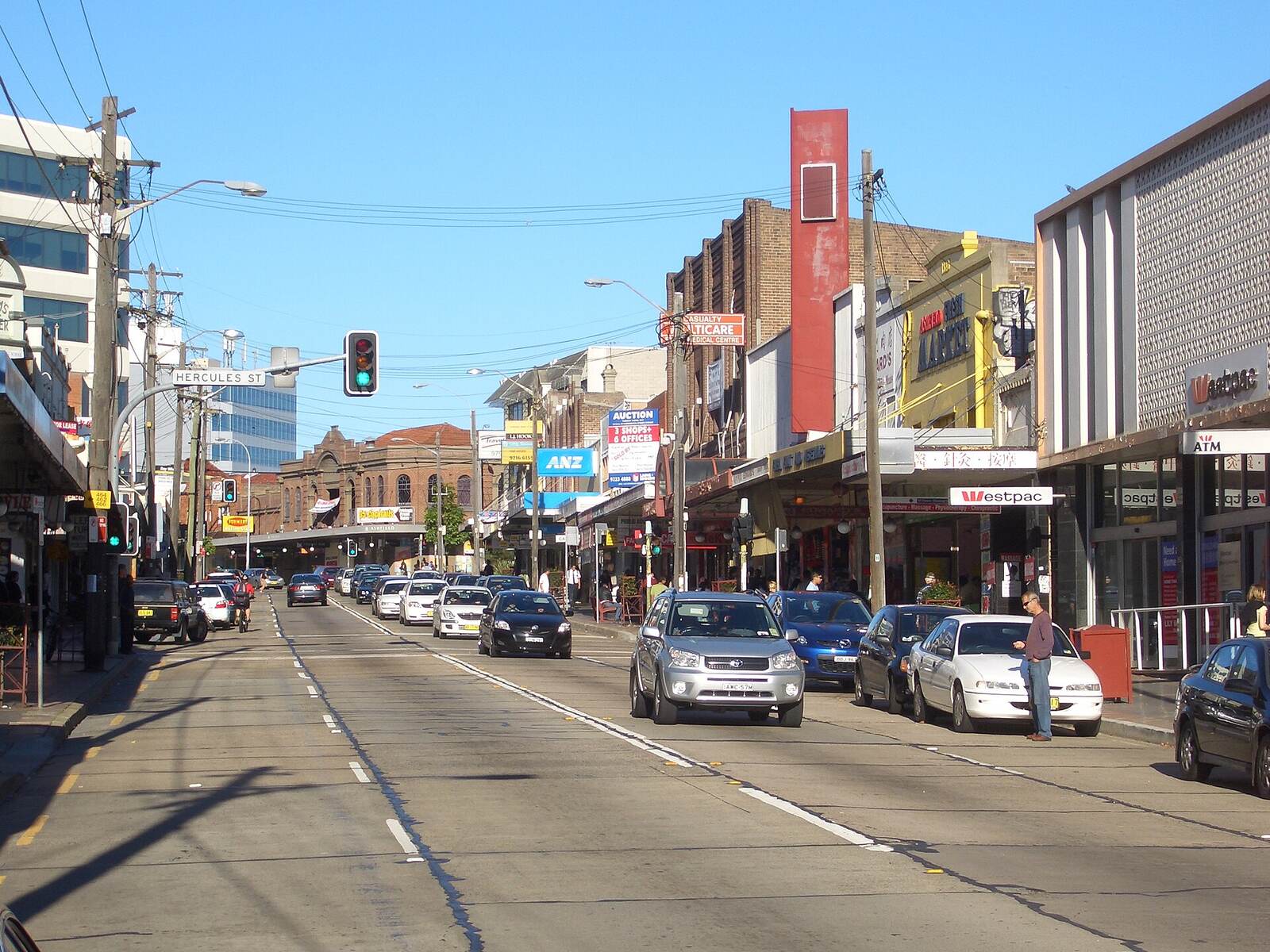 Shops, awnings and traffic lights along Liverpool Road in Ashfield on a clear day
