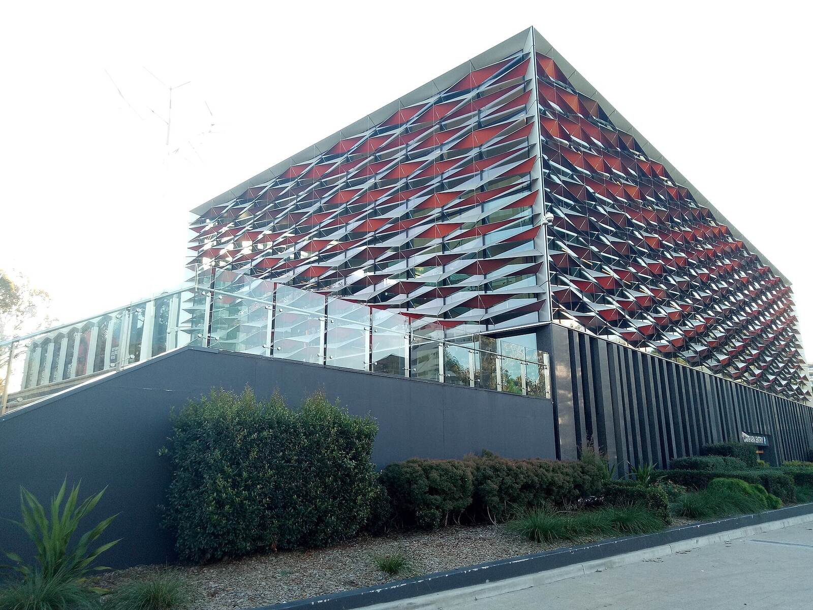 Red and grey patterned fins across the facade of the Bankstown Library and Knowledge Centre on Rickard Road