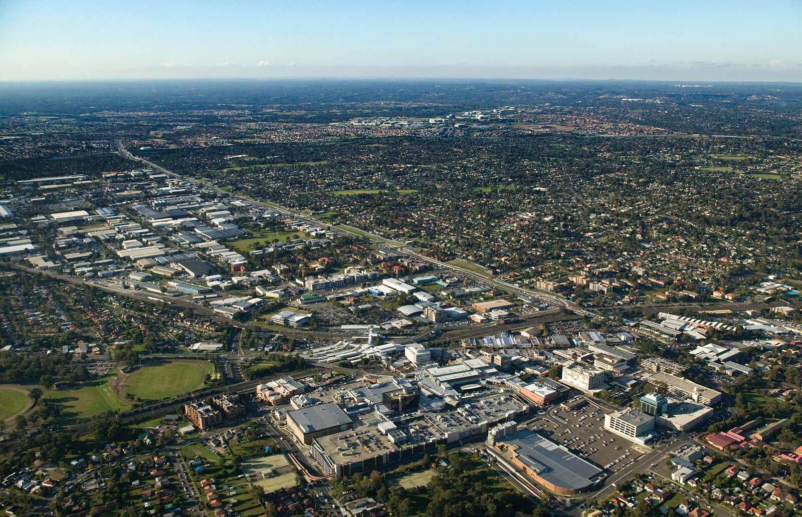 Aerial view over Blacktown looking north-east, with the town centre, railway line and industrial area stretching to the horizon