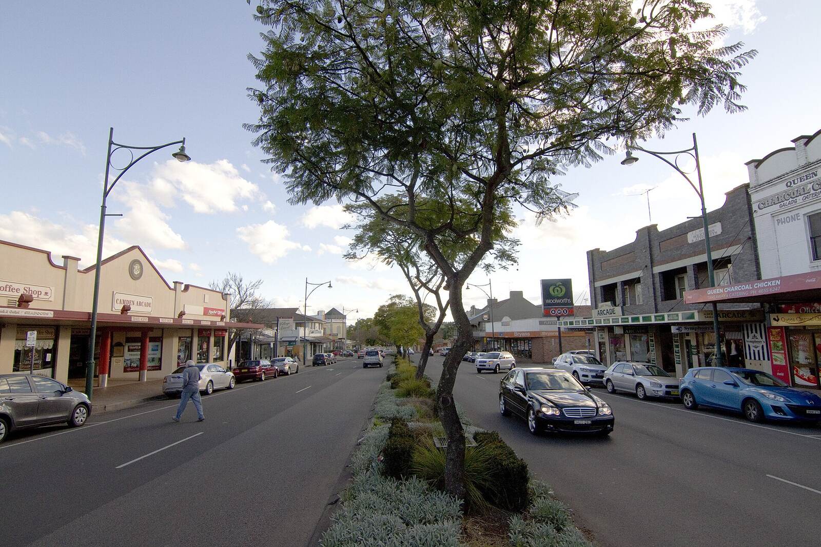Shops, verandahs and a tree-planted median along the main street in Camden town centre