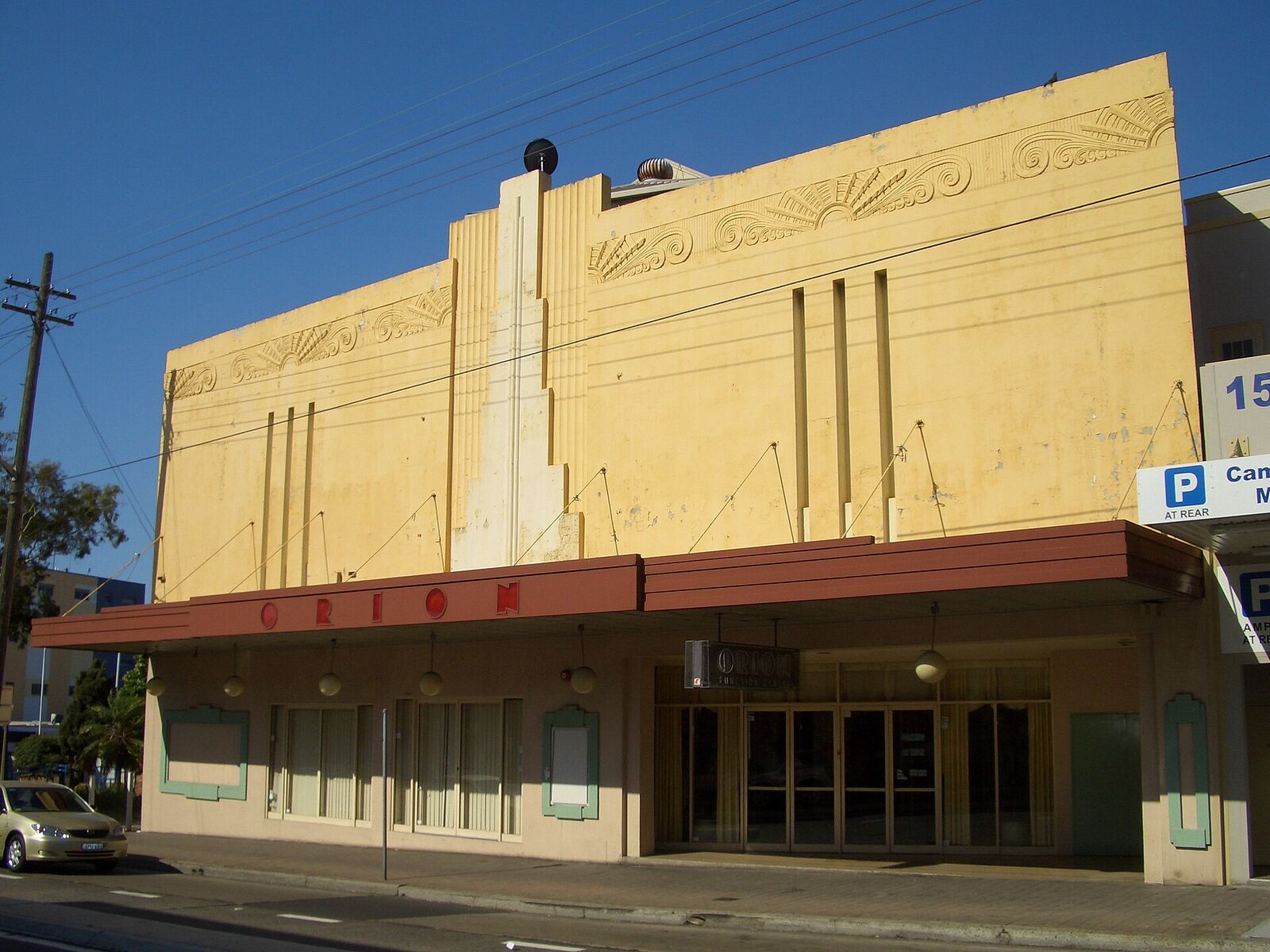 The Art Deco facade of the Orion Centre on Beamish Street, Campsie, under a clear blue sky