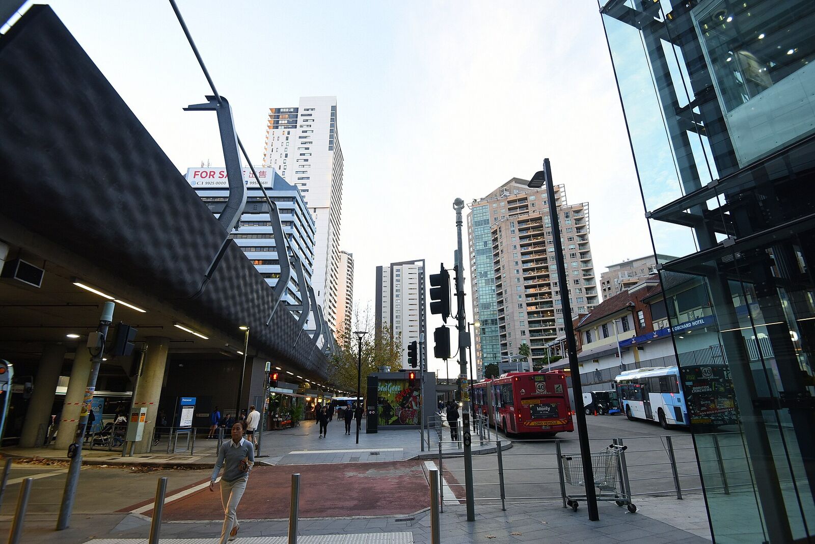 Buses waiting at the Chatswood bus interchange beside the railway, with apartment towers behind