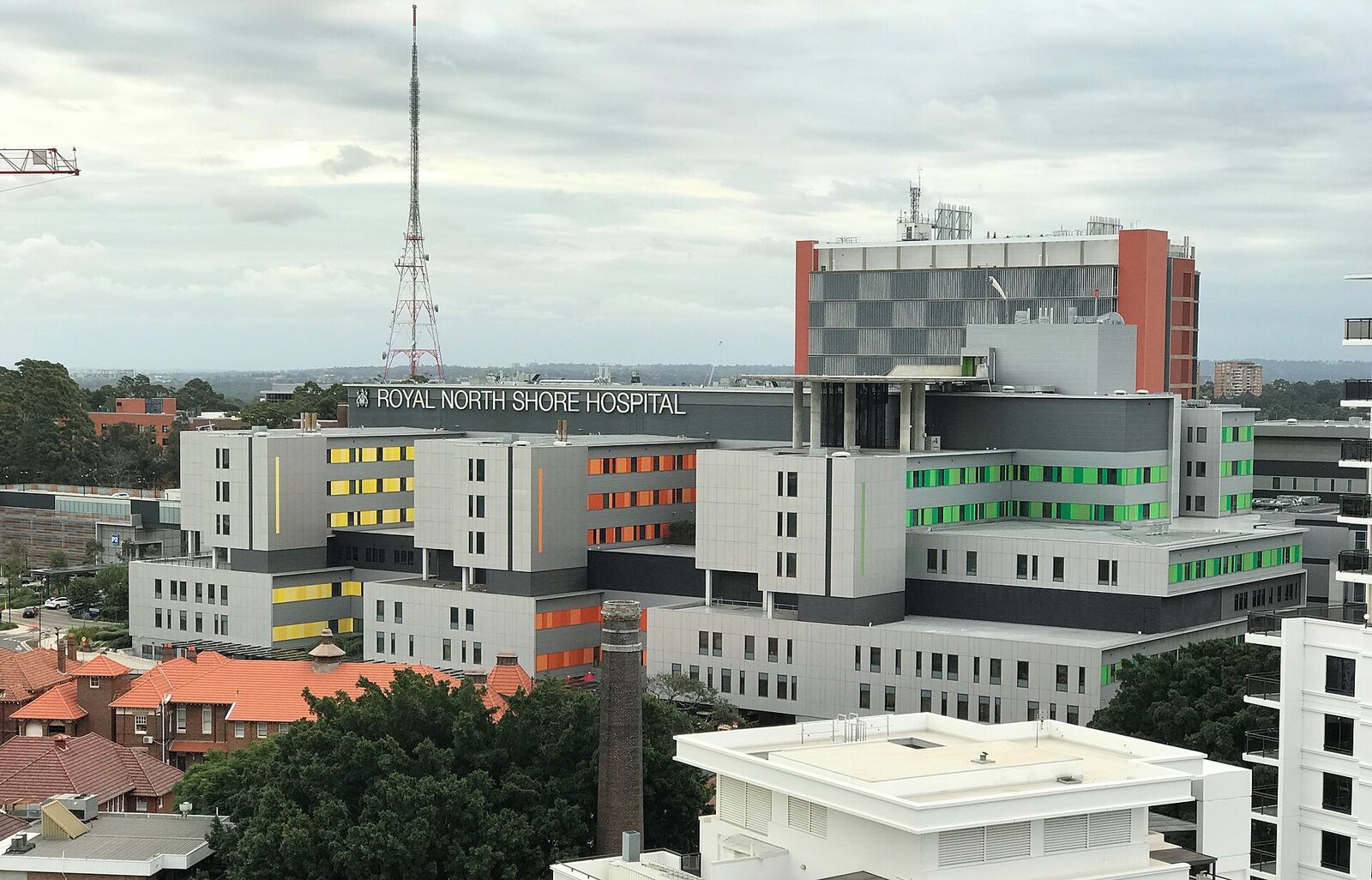 The Royal North Shore Hospital buildings at St Leonards seen over the rooftops, with a TV transmission tower behind