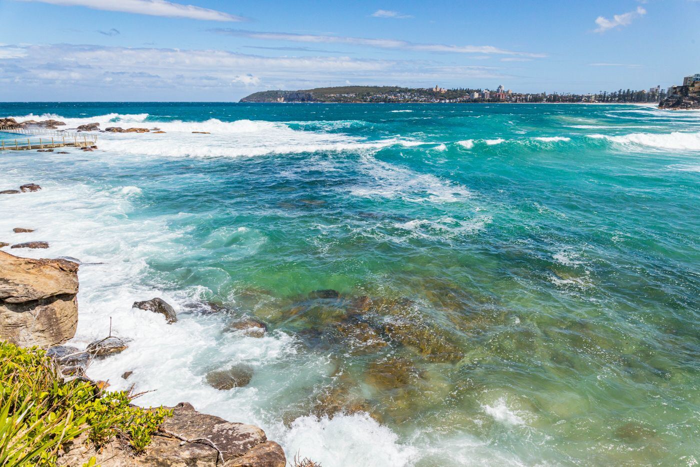 Turquoise waves breaking over the rocks at Freshwater Beach