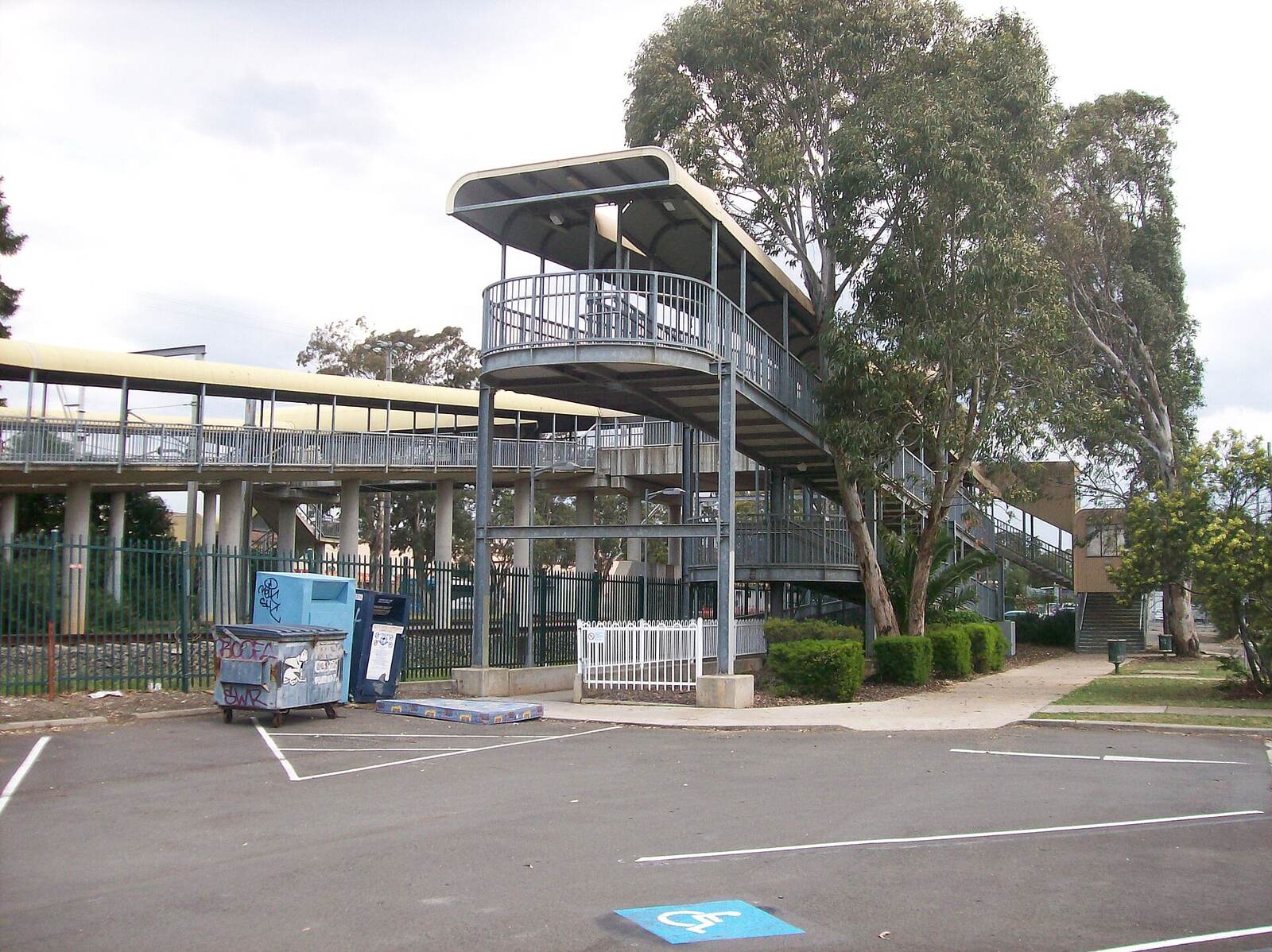 Footbridge stairs and ramp at the western entrance to Ingleburn railway station, next to the car park