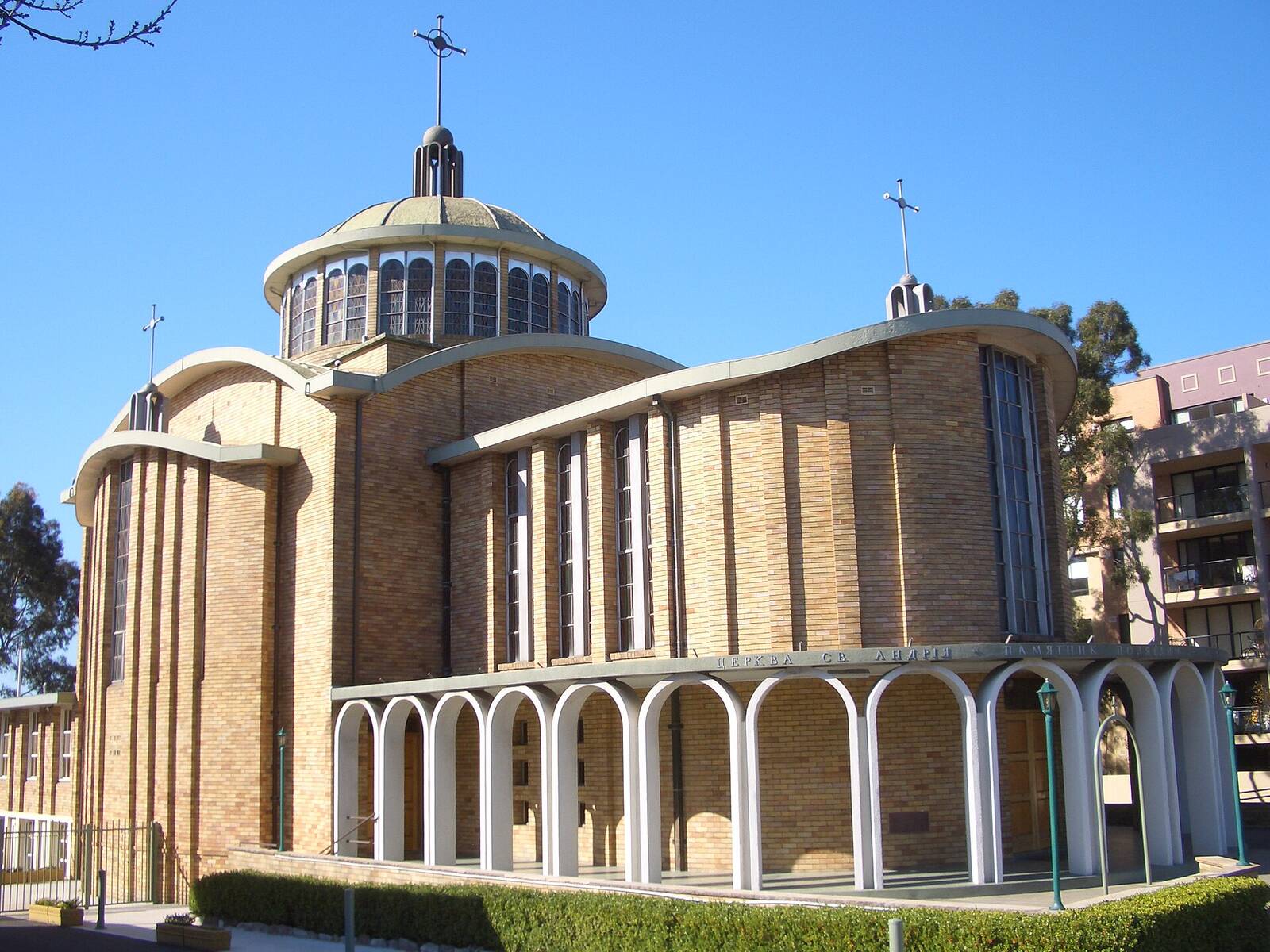 Domed yellow brick St Andrew's Ukrainian Catholic Church with its arched colonnade in Lidcombe