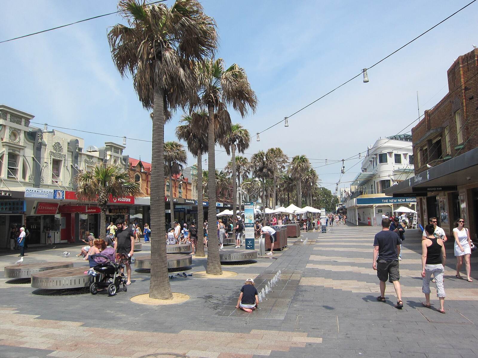 Palm trees and shopfronts along the pedestrian Corso in Manly
