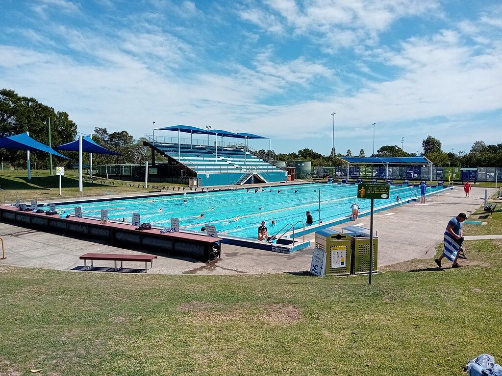Outdoor lap pool and shade sails at Des Renford Leisure Centre in Heffron Park