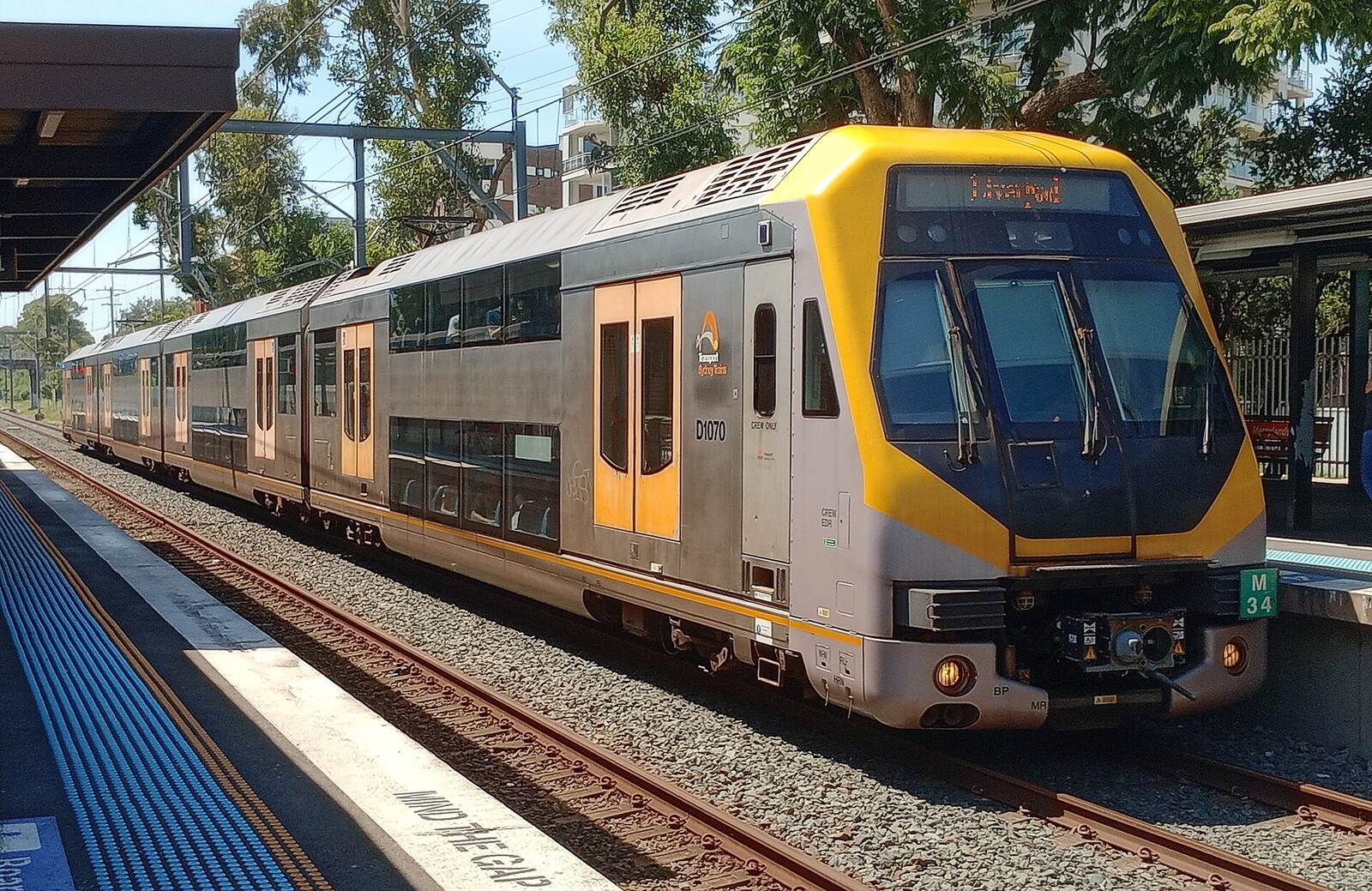 Silver and yellow Sydney Trains double-decker waiting at a Merrylands station platform