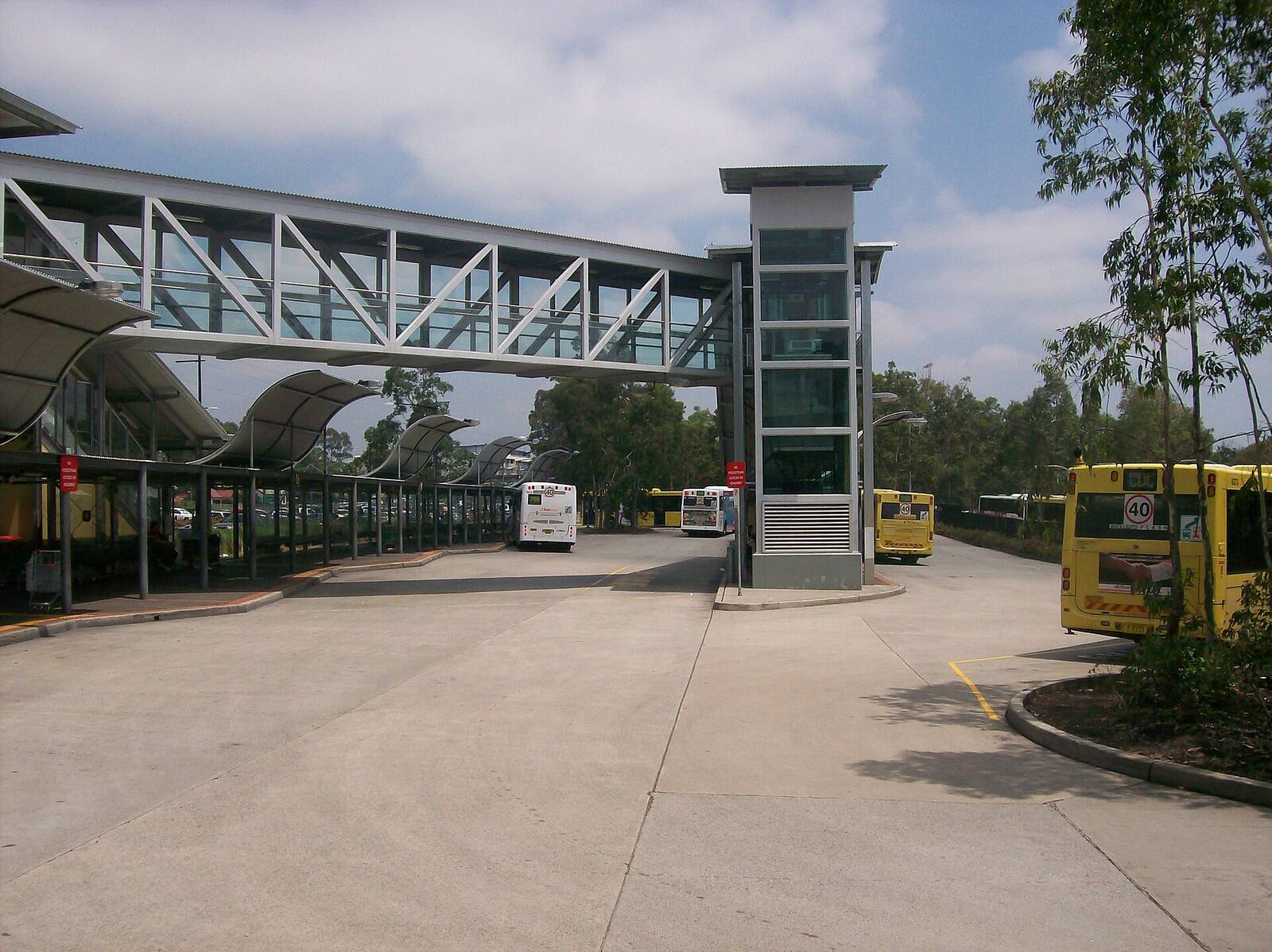 Mount Druitt bus interchange beside the station, with the lift tower and enclosed footbridge over the road