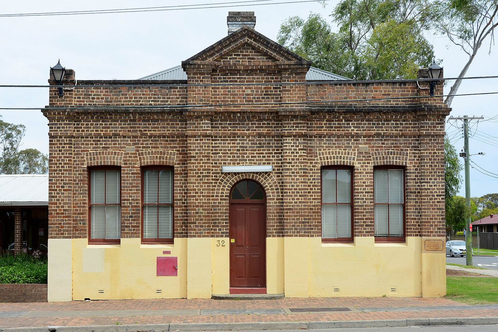 The brick Rooty Hill School of Arts building with arched doorway on Rooty Hill Road South
