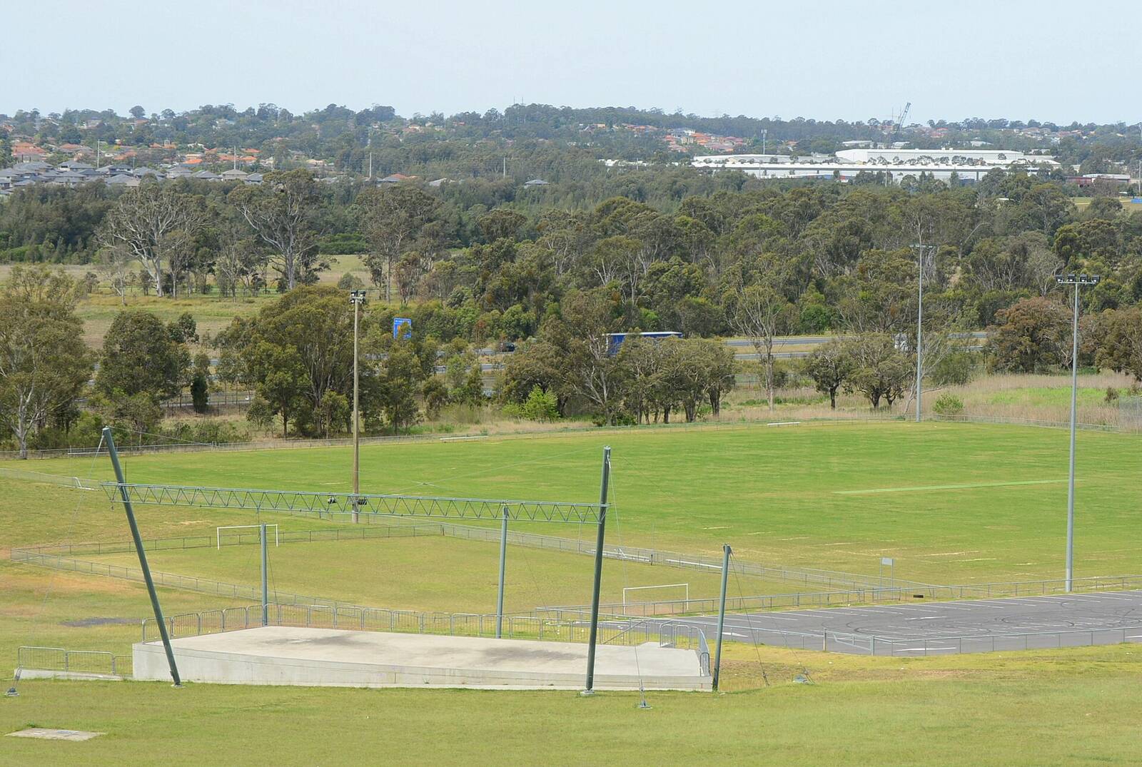 View from the top of the Rooty Hill across the playing fields of Morreau Reserve towards bushland and houses
