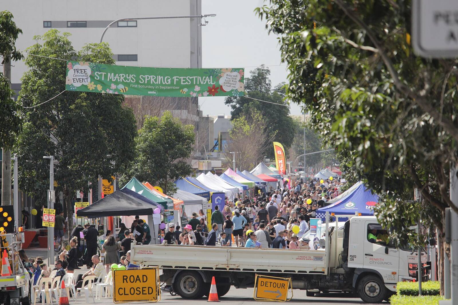 Queen Street closed to traffic for the St Marys Spring Festival, with market stalls, crowds and a Road Closed sign