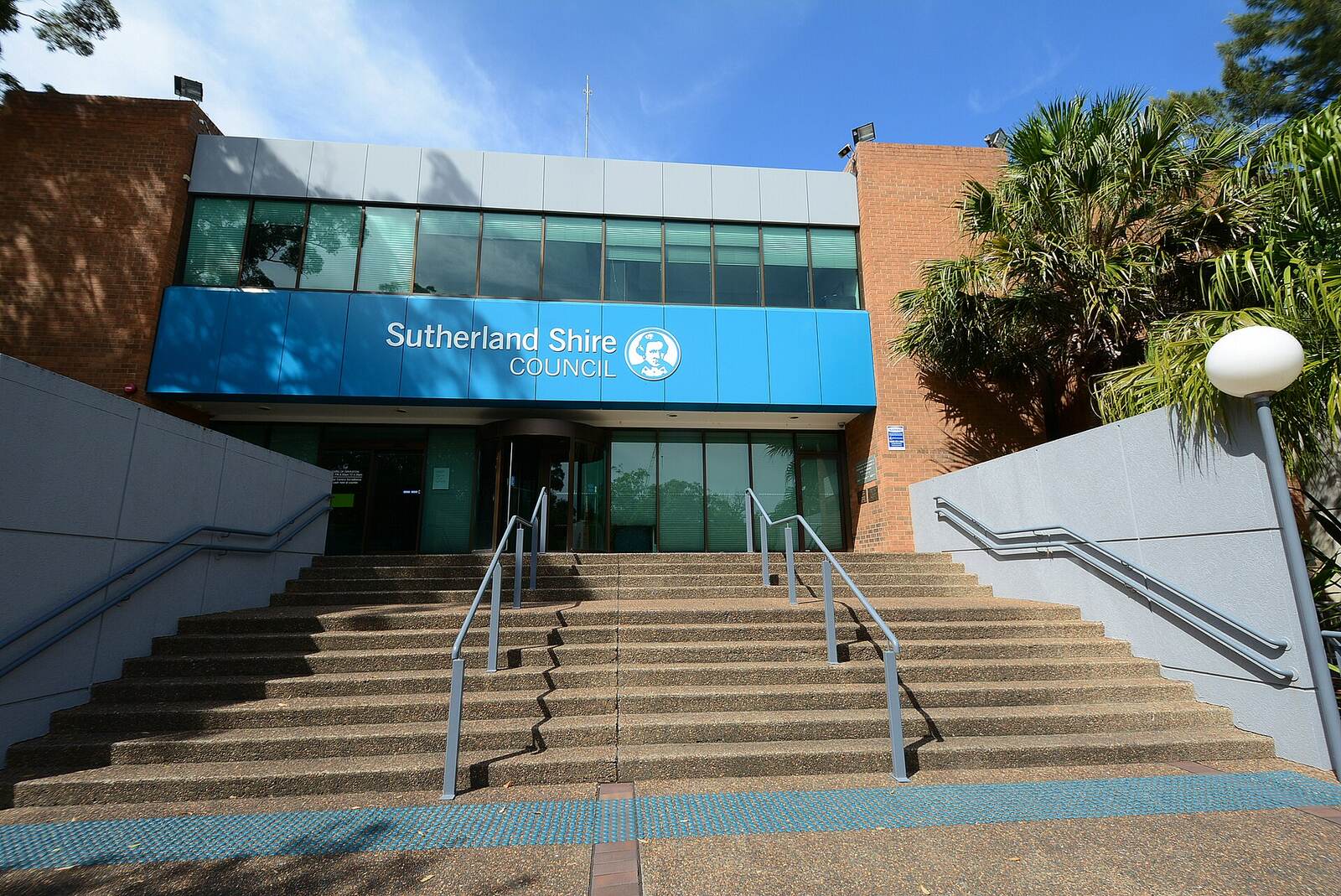 Front steps and blue signage of the Sutherland Shire Council administration building on Eton Street