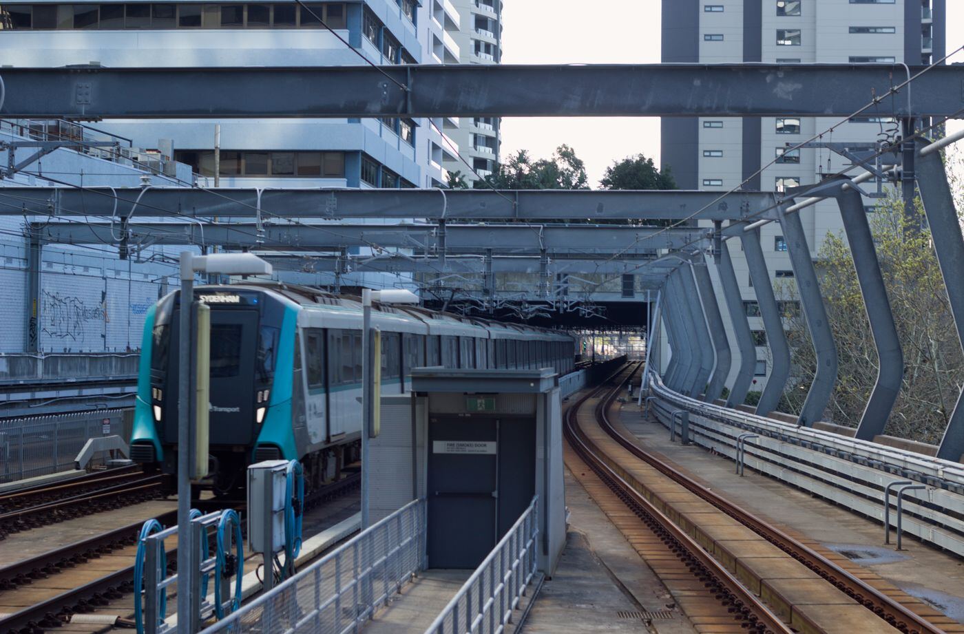 Sydney Metro train waiting at an elevated station platform