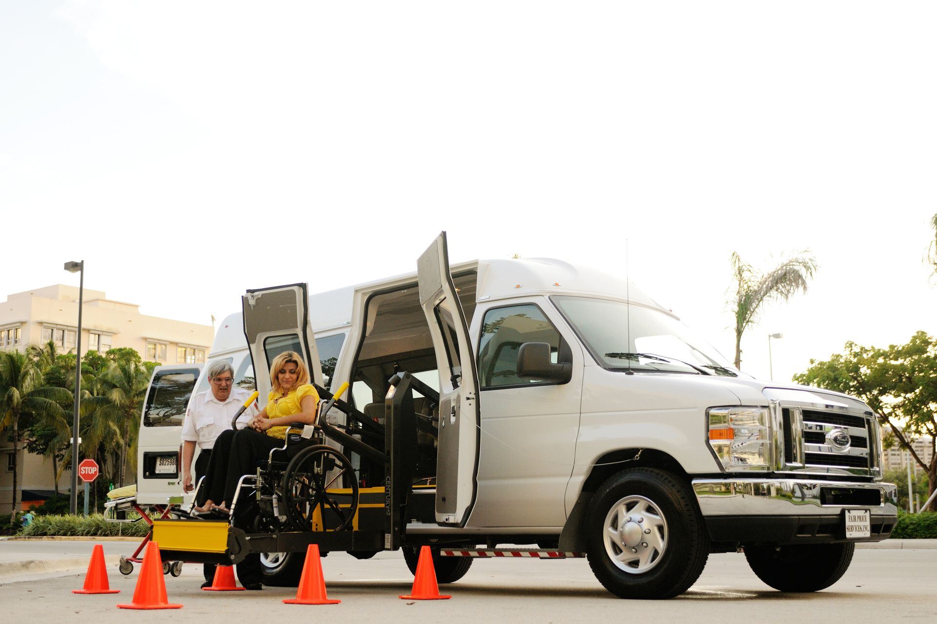 Passenger in a wheelchair boarding a van on its rear lift