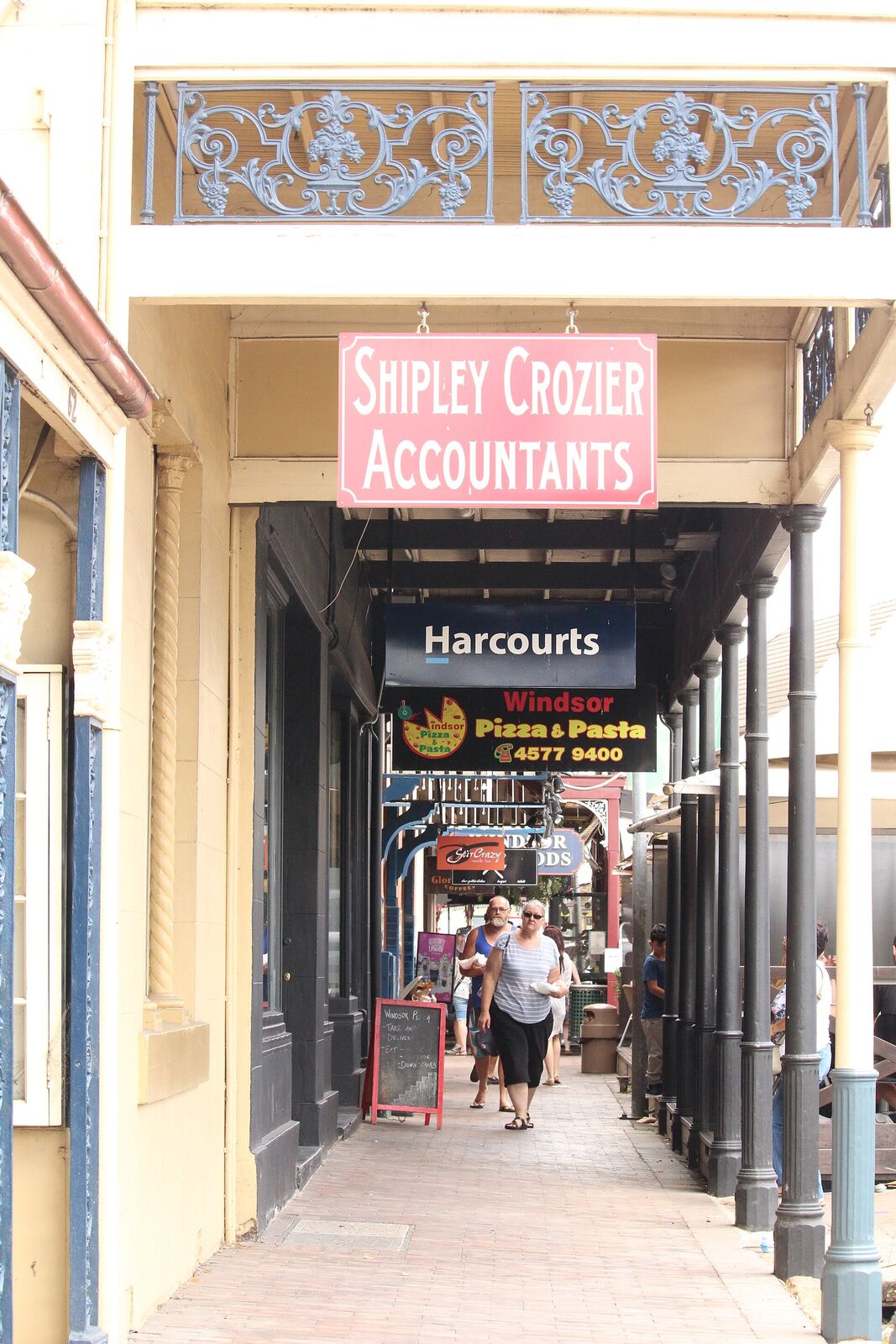 Iron lace and timber posts on the shop verandahs over the George Street footpath at Thompson Square, Windsor